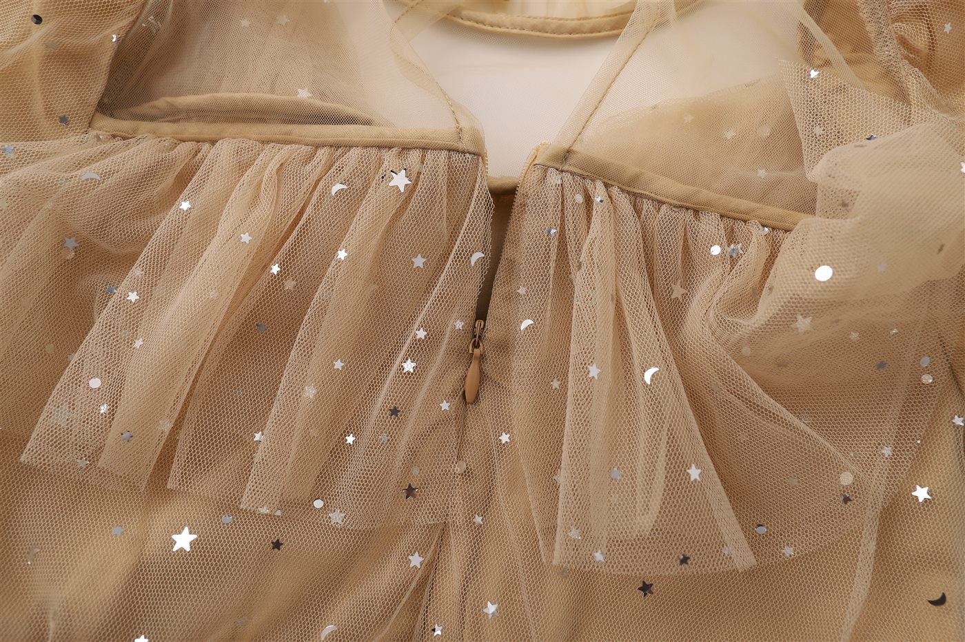 Close-up of tulle children's garment with star details